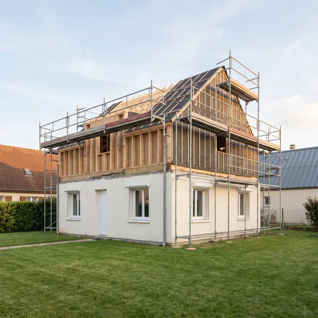 Surélévation en ossature bois sur une maison existante, sous échafaudage (image d’illustration)